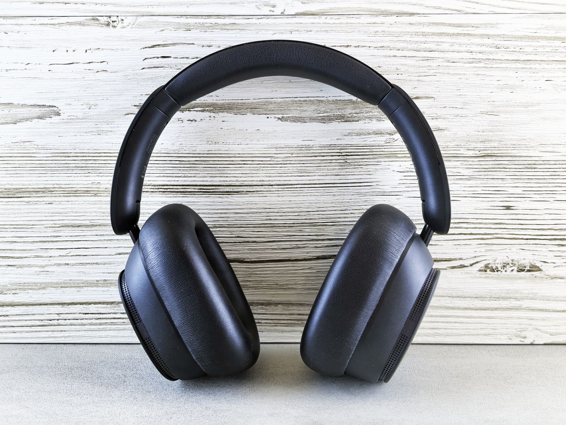 Over-ear noise-cancelling headphones on a minimal wood desk